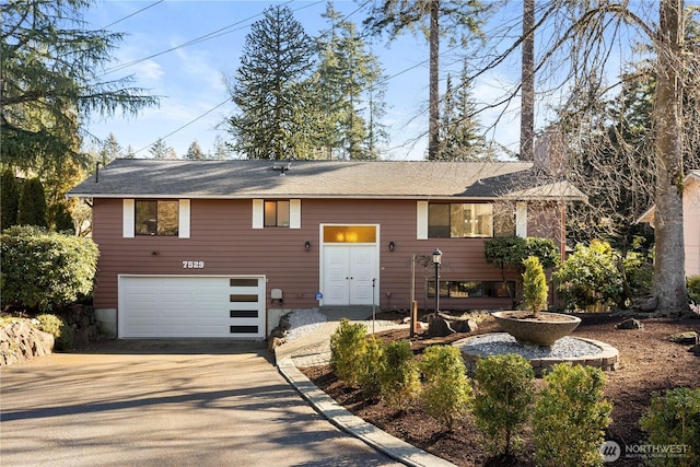 view of front of home with concrete driveway and an attached garage