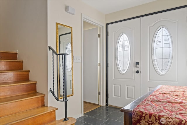 foyer featuring dark tile patterned flooring