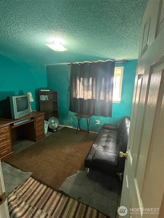 bedroom featuring a textured ceiling and carpet