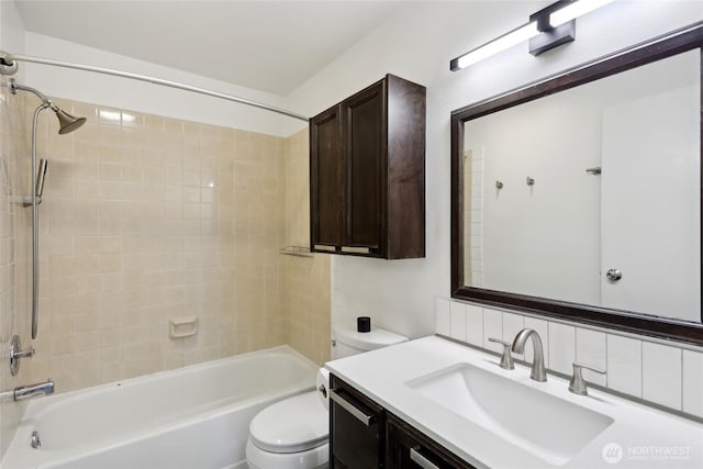 bathroom featuring toilet, tub / shower combination, and vanity