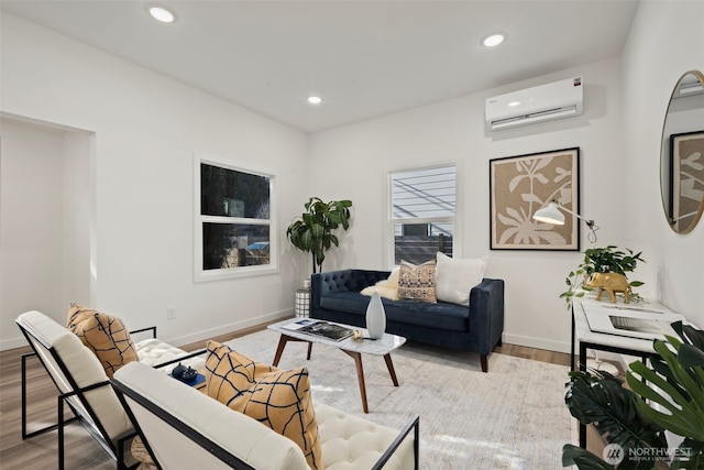 living room featuring a wall mounted air conditioner and light hardwood / wood-style floors