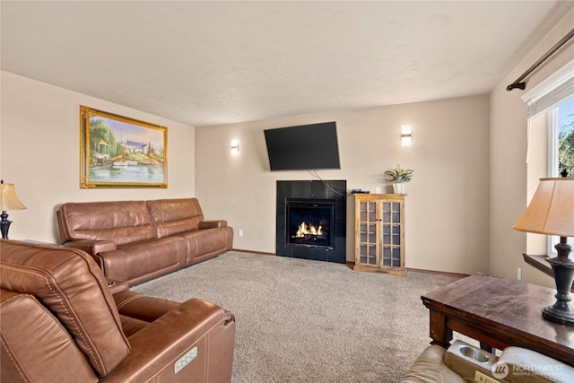 living room featuring a tiled fireplace and carpet