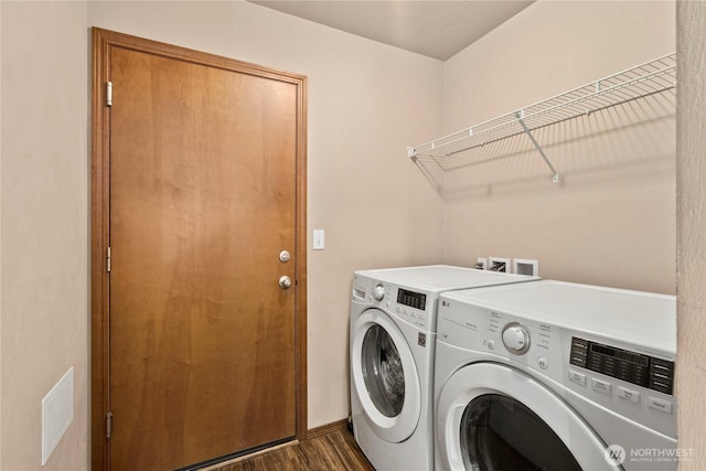 laundry room with dark hardwood / wood-style flooring and washer and dryer