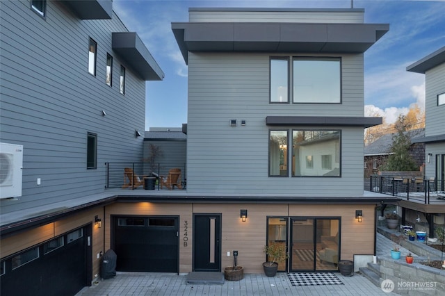 rear view of house featuring a garage