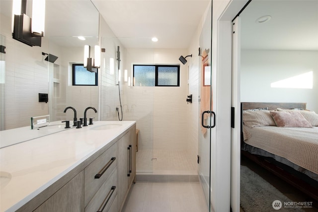 bathroom with vanity, an enclosed shower, and tile patterned flooring