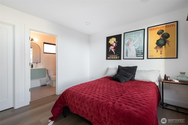 bedroom with wood-type flooring and ensuite bathroom