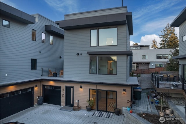 rear view of property featuring a garage