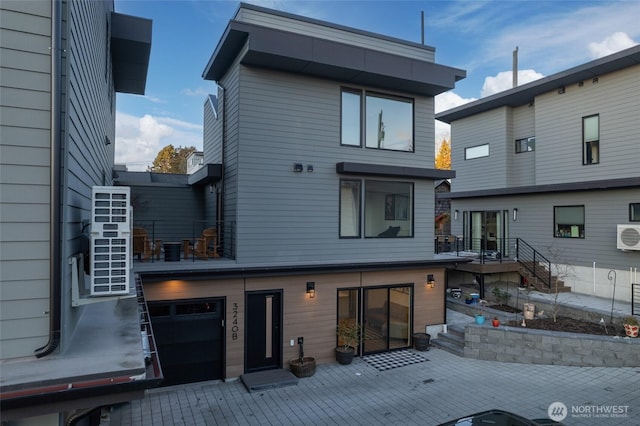 rear view of house featuring a garage