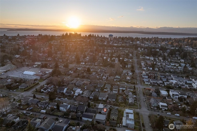 aerial view at dusk with a water view