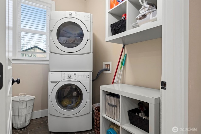 washroom featuring stacked washer and clothes dryer