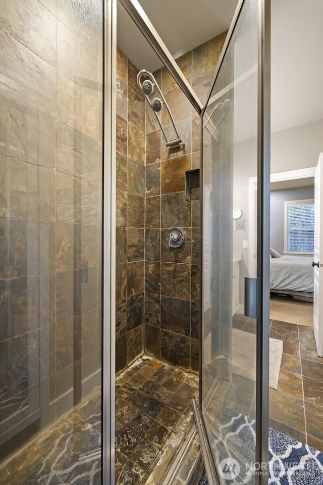 bathroom featuring a shower with shower door