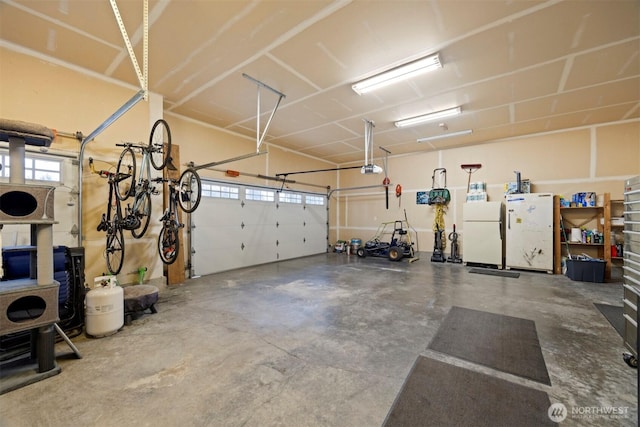 garage featuring white fridge