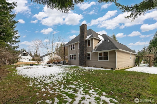 rear view of property featuring a pergola and a lawn