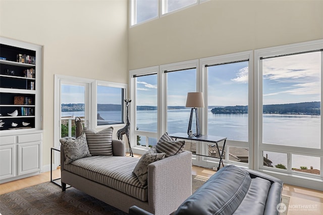 sunroom / solarium with a water view