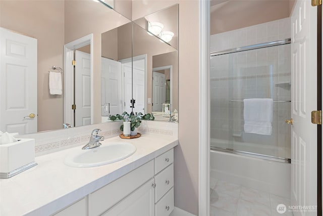 bathroom with vanity and combined bath / shower with glass door