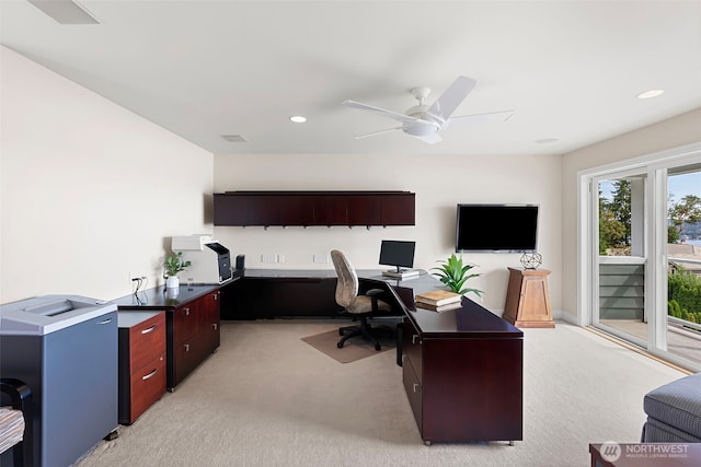 office space with ceiling fan and light carpet