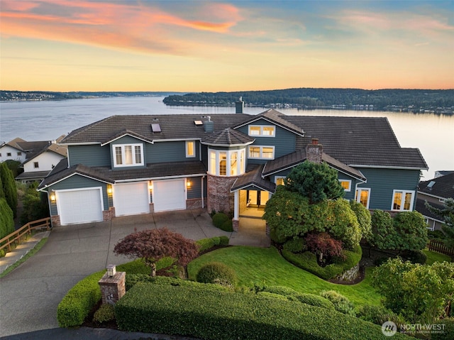 view of front of home featuring a garage and a water view