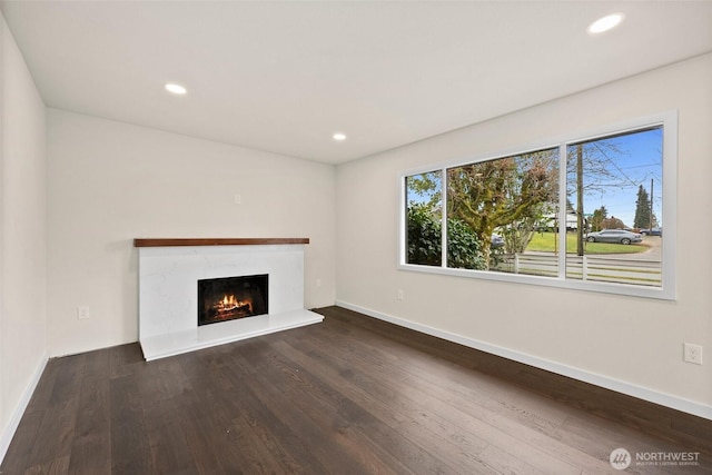 unfurnished living room featuring dark hardwood / wood-style flooring