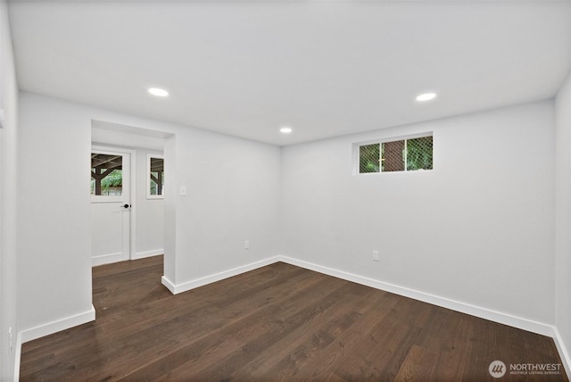 unfurnished room featuring plenty of natural light and dark hardwood / wood-style flooring