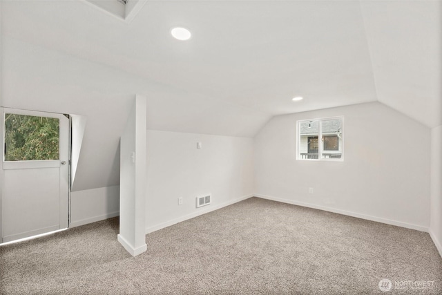 additional living space with lofted ceiling and carpet floors