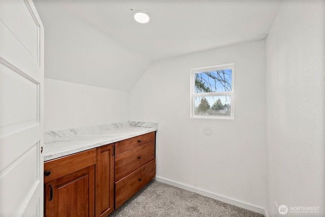 bathroom featuring lofted ceiling