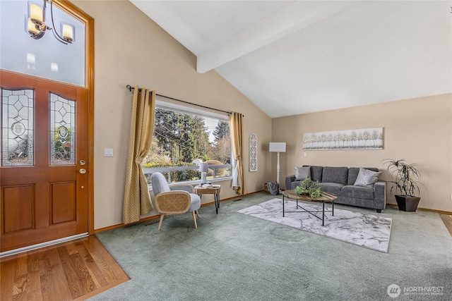 foyer with vaulted ceiling with beams and carpet floors