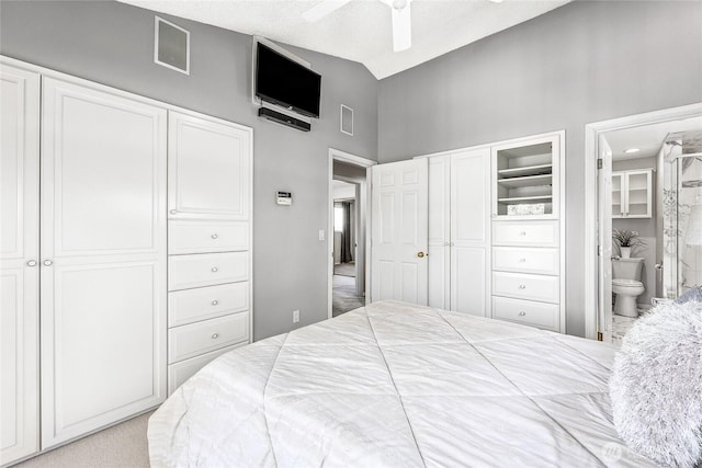 bedroom featuring vaulted ceiling, connected bathroom, and ceiling fan