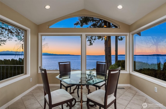 sunroom featuring vaulted ceiling and a water view