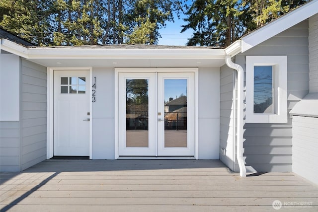 property entrance with a deck and french doors