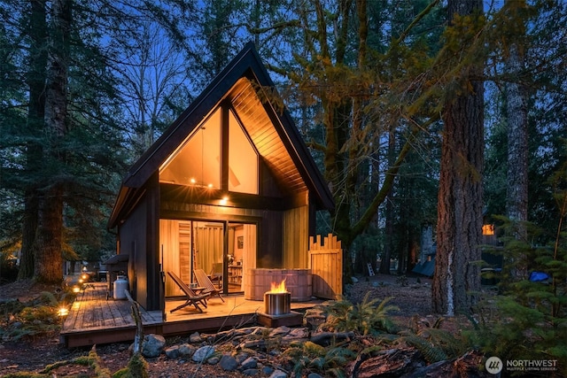 rear view of property with a wooden deck