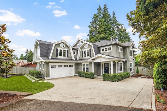 view of front of house featuring a garage and a front lawn