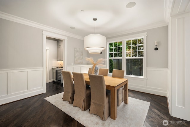 dining room featuring dark wood-type flooring and ornamental molding