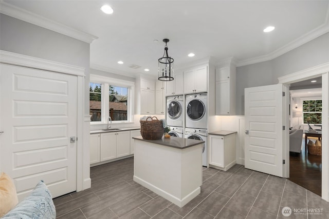 kitchen with white cabinetry, a kitchen island, and pendant lighting