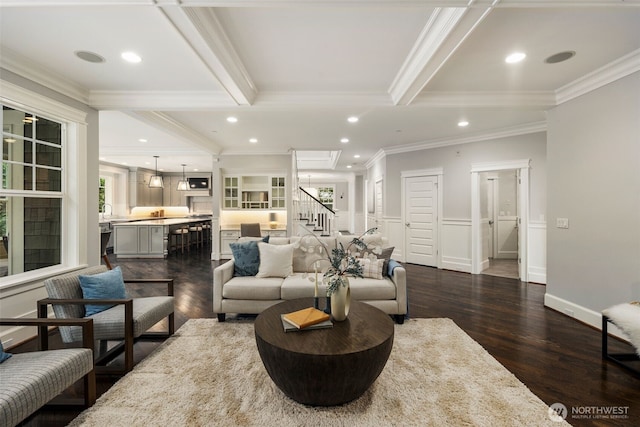 living room with dark wood-type flooring, crown molding, and beamed ceiling