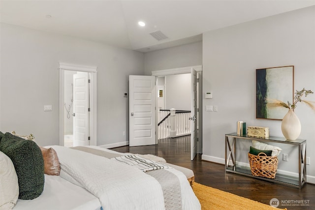 bedroom with dark hardwood / wood-style floors