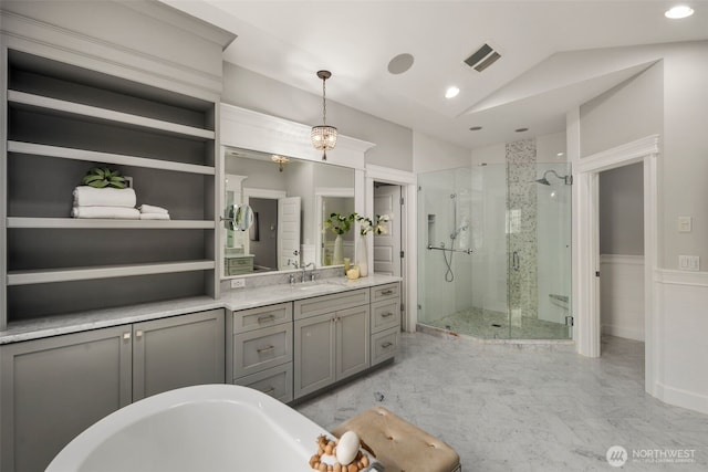 bathroom featuring vanity, vaulted ceiling, and independent shower and bath