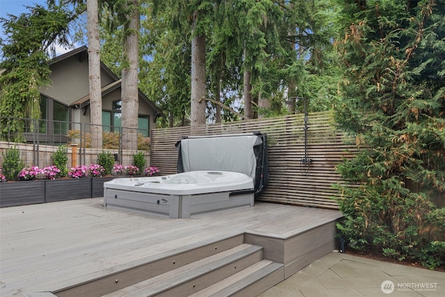 wooden deck with a covered hot tub