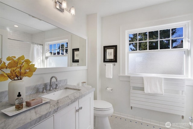 bathroom featuring toilet, vanity, tile patterned flooring, and a shower with curtain