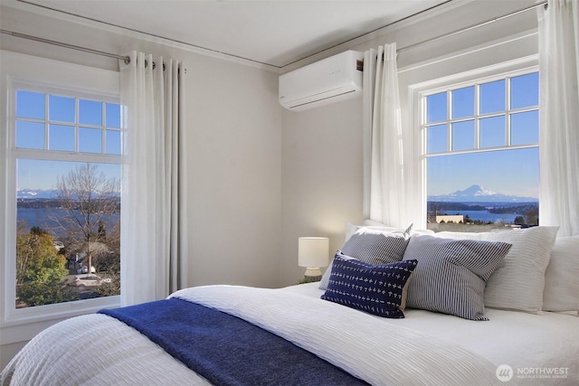 bedroom with a mountain view and an AC wall unit