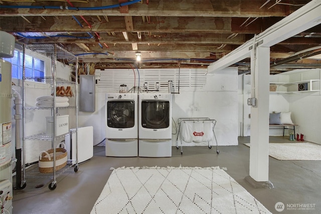 clothes washing area with electric panel and washer and clothes dryer