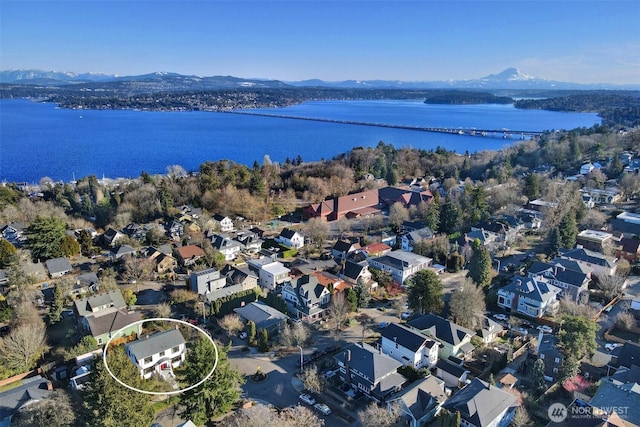 birds eye view of property featuring a water and mountain view