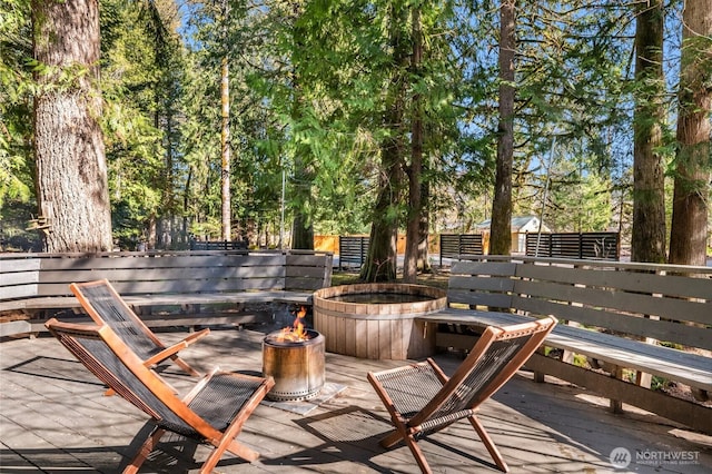 wooden terrace featuring a fire pit