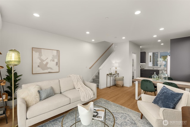 living room featuring light hardwood / wood-style flooring and sink