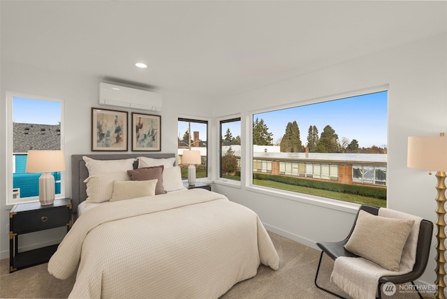 carpeted bedroom featuring multiple windows and a wall mounted air conditioner