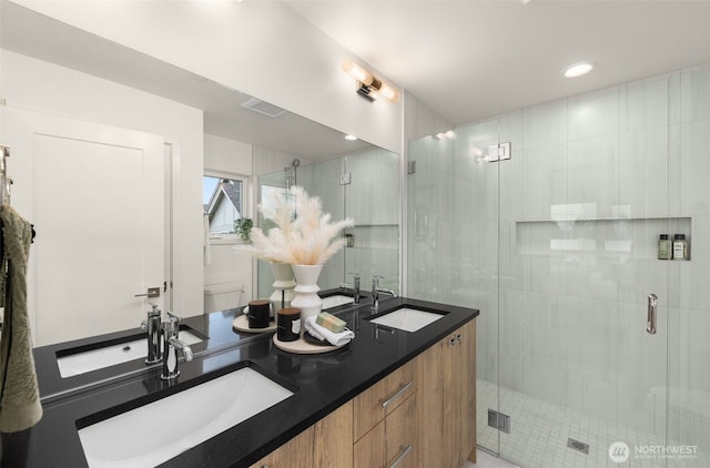 bathroom with vanity and a shower with shower door