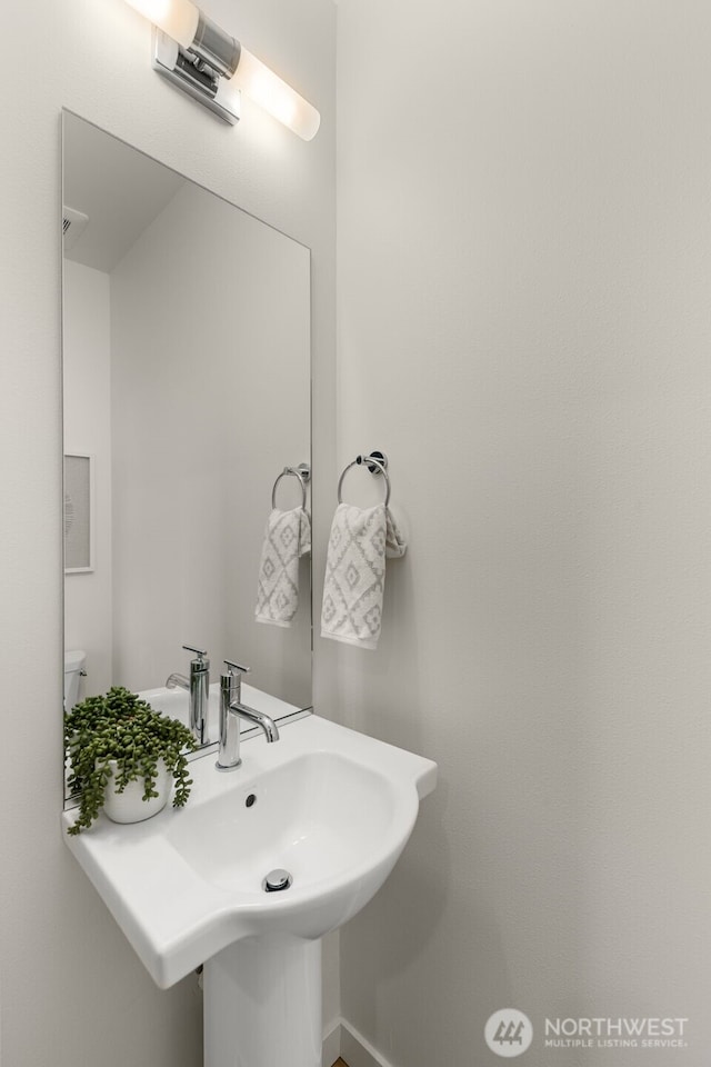 bathroom featuring sink and toilet