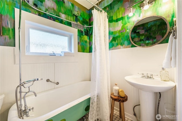 full bathroom with sink, shower / tub combo with curtain, and toilet