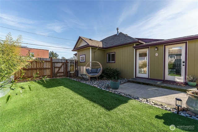 rear view of property with a yard and a patio