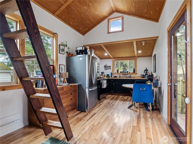 home office featuring wood ceiling, lofted ceiling, a wealth of natural light, and light wood-type flooring