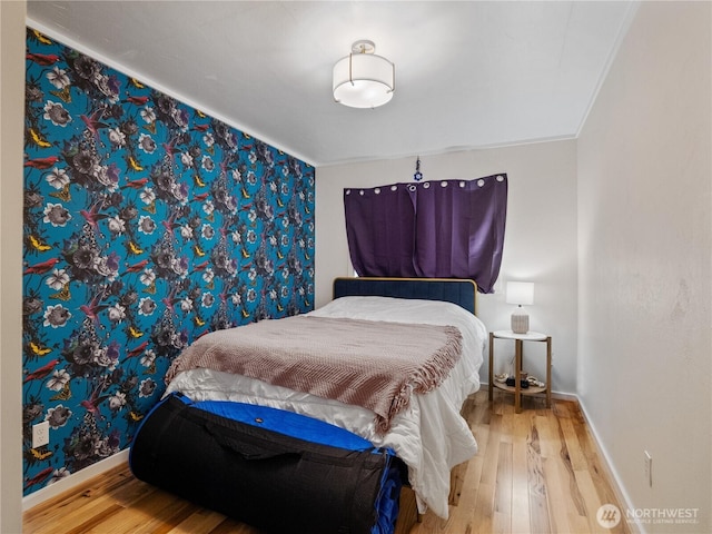 bedroom featuring crown molding and hardwood / wood-style floors